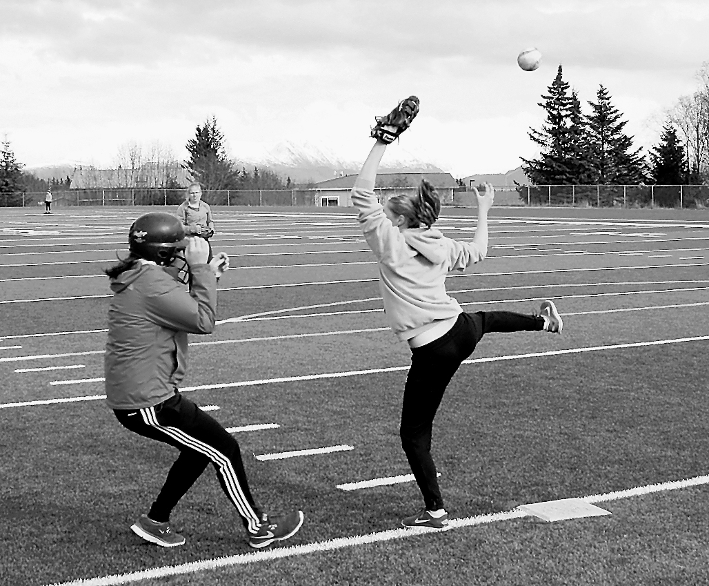 Above, players miss a catch while scrimmaging.-Photos by Lindsay Olsen