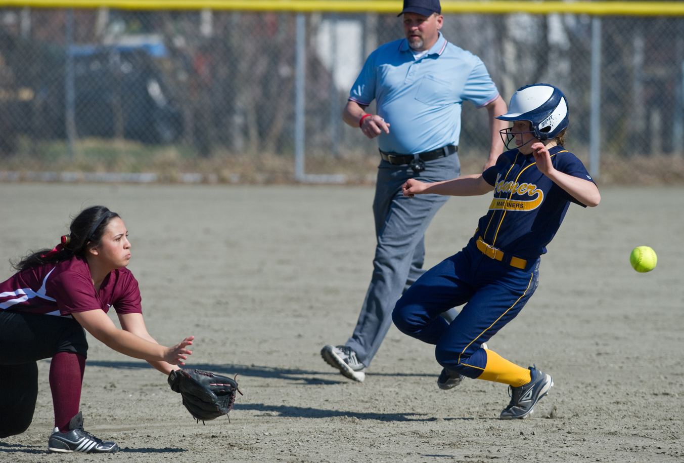 Homer’s Maggie LaRue, right, beats the throw to second as Ketchikan’s Jazmyn Nedzwecky readies for the ball in a May 1 game in Juneau. Ketchikan won the game 9-1. Field umpire Mark Potts is there to make the call.-Michael Penn, Juneau Empire