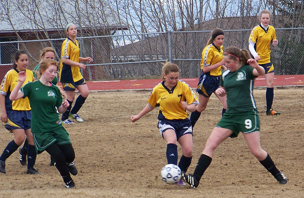Mariner Sydney Lee, center, goes toe-to-toe against a Colony player. -Photo by McKibben Jackinsky, Homer News