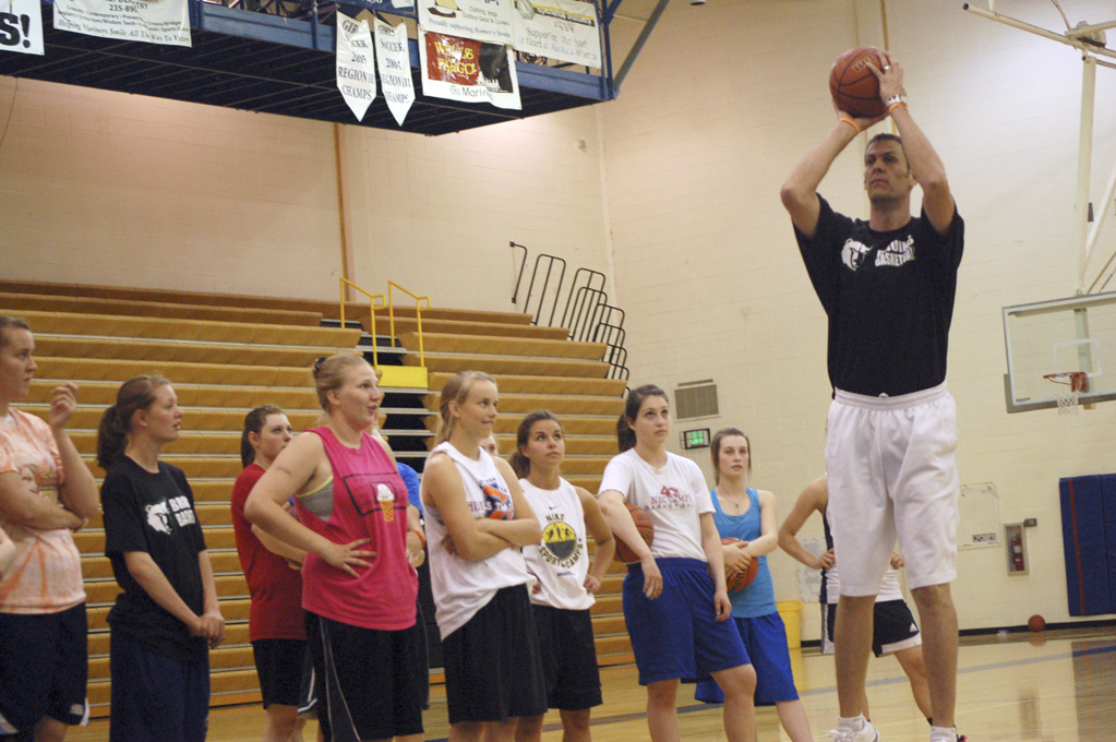 Matt Garrison,  right, gives a group of girl basketball players tips at a shooting clinic last Friday.-Photo by Michael Armstrong, Homer News