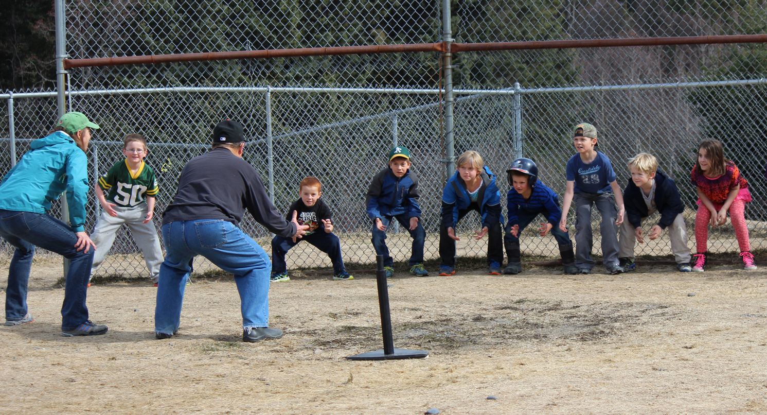 Facing the Paul Banks baseball team, coaches Kate Crowley and Don Felton lead warmups. The team, from left: Einar Pedersen, Josh Rudolph, Carter Collins, Sydney Shelby, Cutter Shelby, Nathaniel Theisen, Henry Wedvik and Paige Haines.-Photo by McKibben Jackinsky, Homer News
