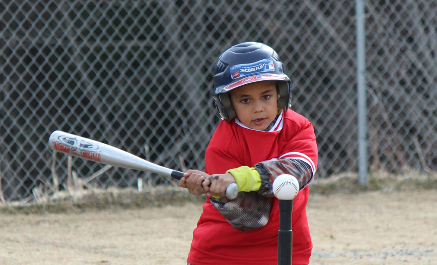Tegan Garza takes aim at the baseball.-Photo by McKibben Jackinsky, Homer News