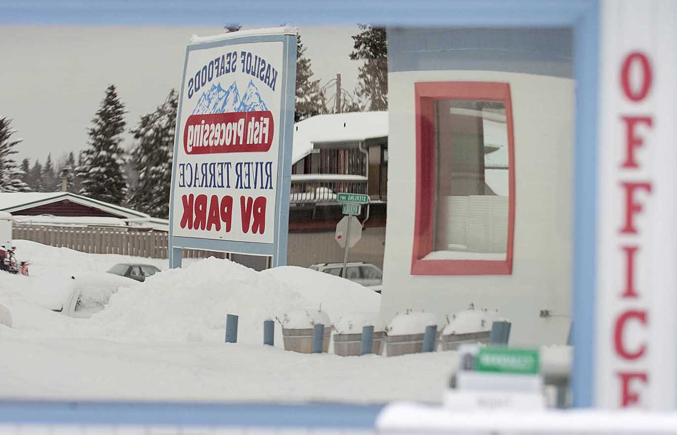 A sign in front of the River Terrace RV Park in Soldotna is reflected in an office window. The RV park is participating in the city's storefront improvement grant program.