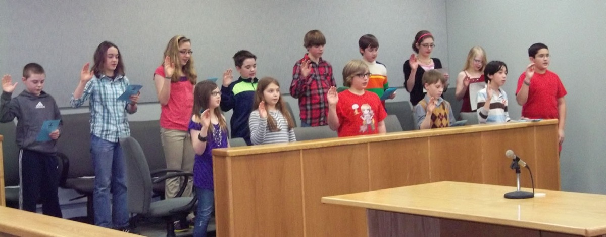 Kenai Peninsula Youth Court members (back row from left) Dexter Lowe, Ali McCarron, Brenna McCarron, Michael Munns, Caleb Rauch, Cole Roberts, Rylyn Todd, Audrey Wallace, (front row from left) Mya Betts, Autumn Carlson, Parker Gibson, Tom Gorman, Cristian Harrigan and Maxwell Johnson are sworn in at the Homer courthouse Feb. 13.