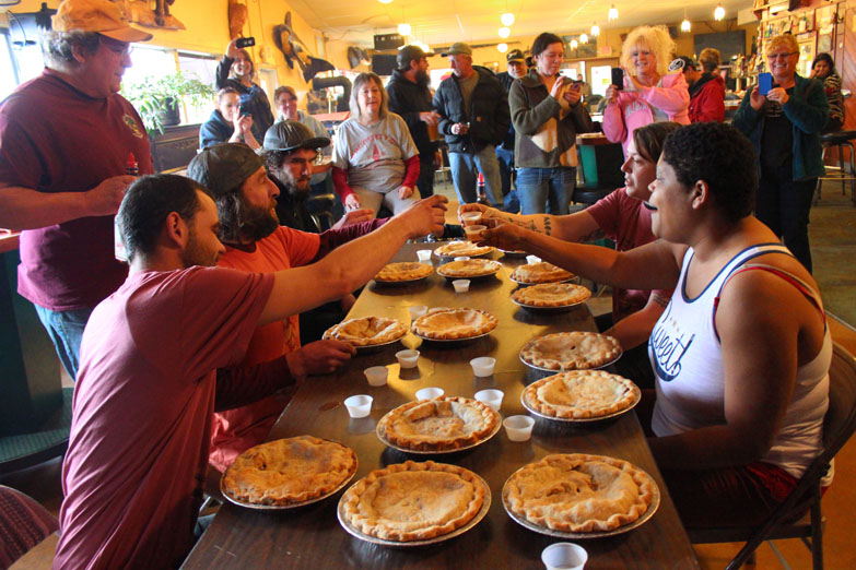 Rocky Berg, Troy Parsons, Kaleb Long, Meghan Kerlin and Sadie Millard toast with a taste of Piehole Whiskey at the start of the Sunday pie-eating contest at Down East Saloon.-Photo by McKibben Jackinsky, Homer News