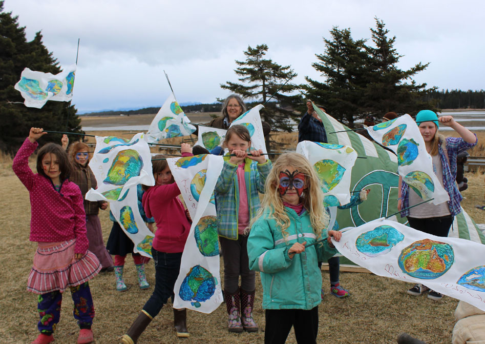 Youngsters display Earth Day prayers flags made with the help of Kiki Abrahamson, in back.-Photo by McKibben Jackinsky, Homer News