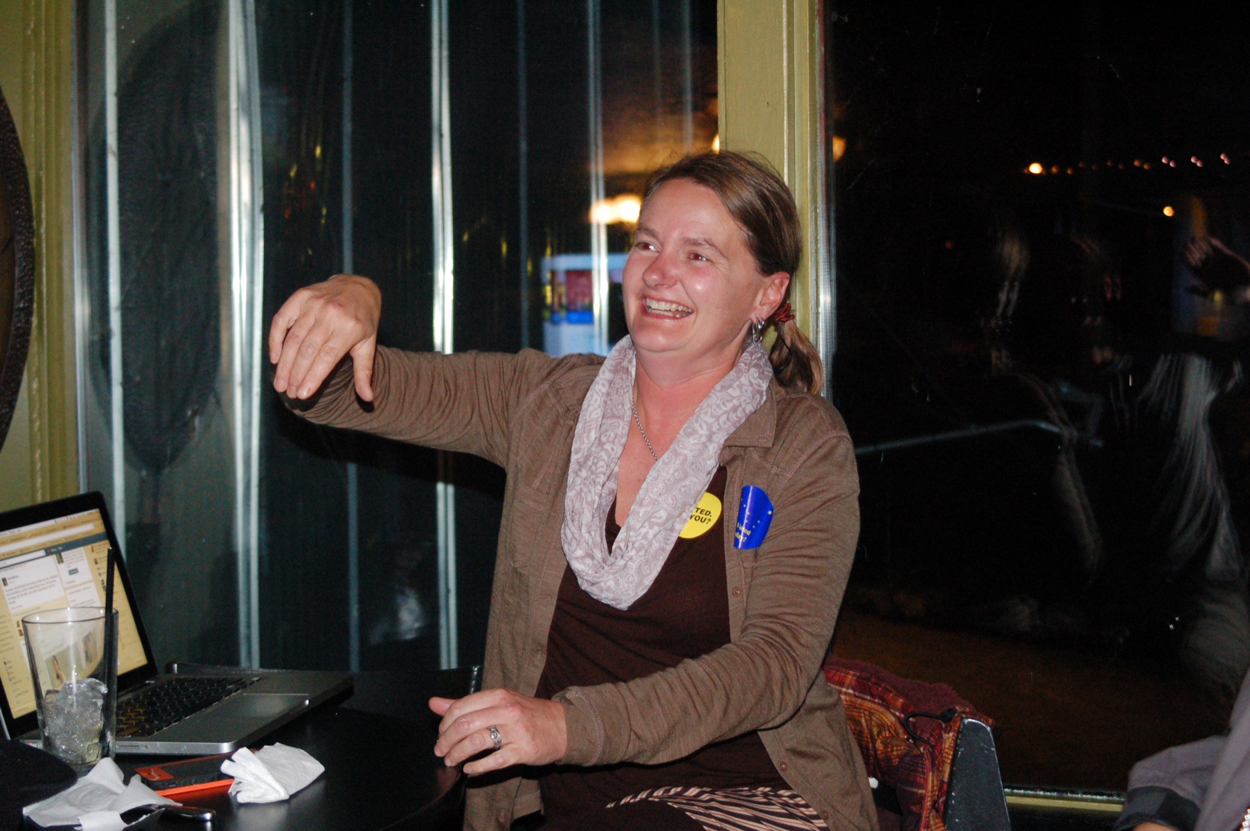 Homer City Council candidate Catriona Lowe smiles after hearing that she won election. Lowe held an informal election party at the Alibi Bar. Mayor Beth Wythe, who was re-elected to a second term, stopped by to congratulate Lowe.-Photo by Michael Armstrong, Homer News