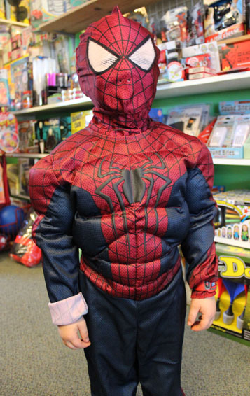 Spiderman Kameron Rogers checks out the toys at Timeless Toys on Saturday before participating in the store’s Halloween party.-Photo by McKibben Jackinsky, Homer News