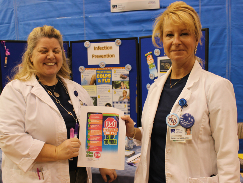 South Peninsula hospital registered nurses Kathi Collett of Quality Improvement, left, and Sherry Catterfeld of Infection Prevention Employee Health, right, distribute information on avoiding the flu, pneumonia, ebola and other infectious diseases at Saturday’s Rotary Health Fair.-Photo by McKibben Jackinsky, Homer News