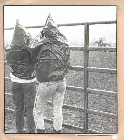 Spectators don’t let rain stop them from enjoying the Happy Valley Fourth of July Rodeo in 1991.-Homer News archive photo