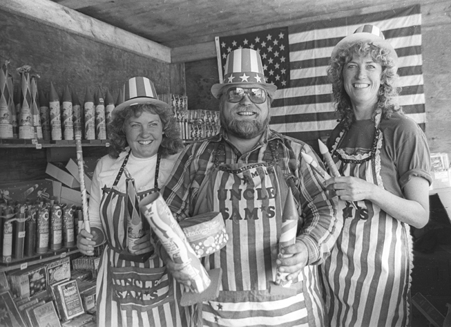 Suzanne and Mark Stevens, left, and Peggy James staff Uncle Sam’s Fireworks Stand on Baycrest Hill. Fireworks were then legal to sell in Homer.-Homer News archive photo