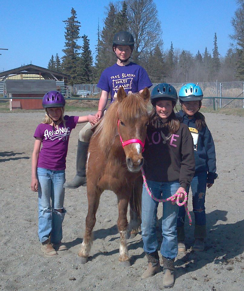 Angela Beplat, second from right, and horse Sally offer a mock horse therapy lesson to Robin Wiese, left, Jazzy Frankhouser, center, and Riana Boonstra, right.-Photo by Jeannie Fabbich
