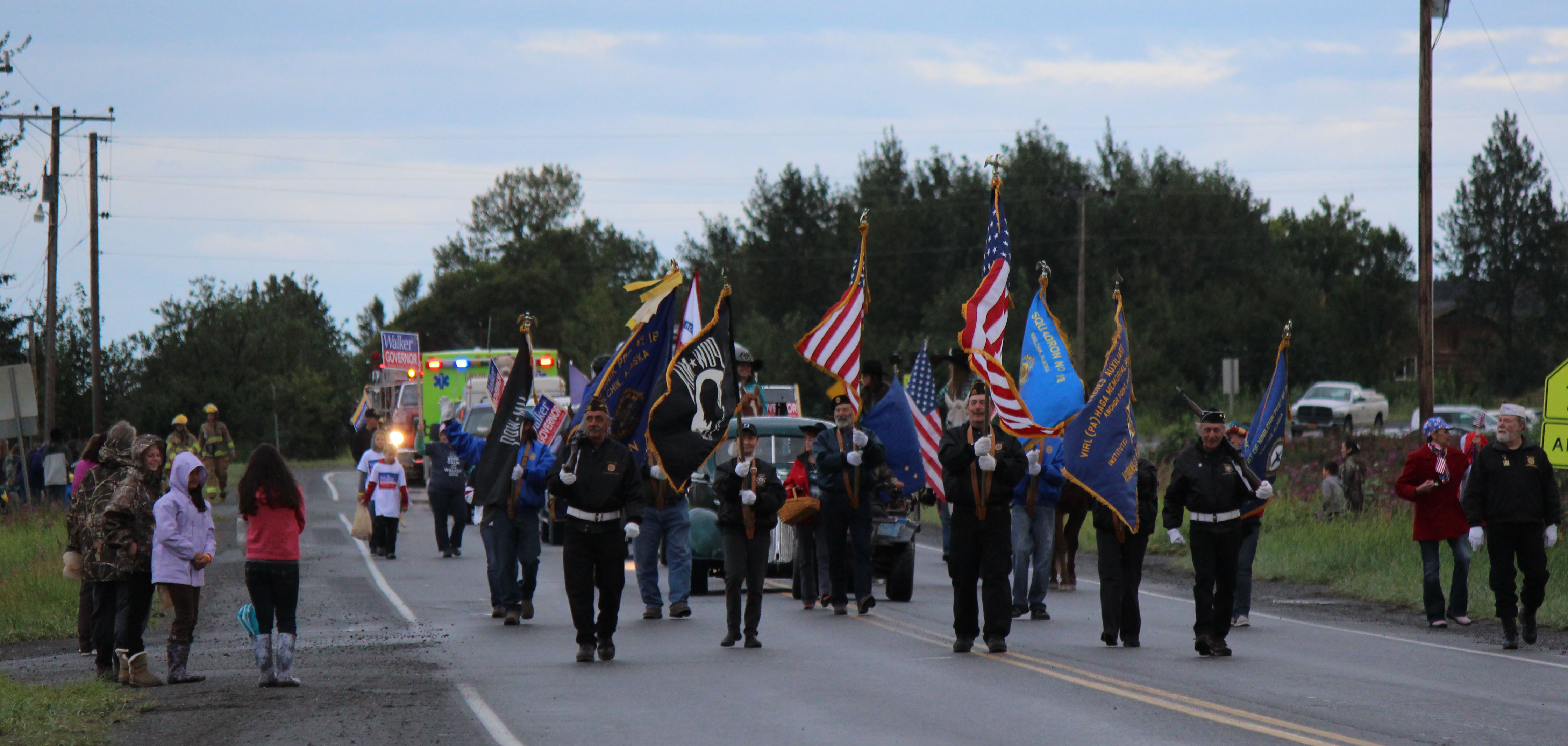 A color guard from Veterans of Foreign Wars Post 10221 in Anchor Point leads the Kenai Peninsula Fair parade Saturday morning in Ninilchik.-Photo by McKibben Jackinsky; Homer News