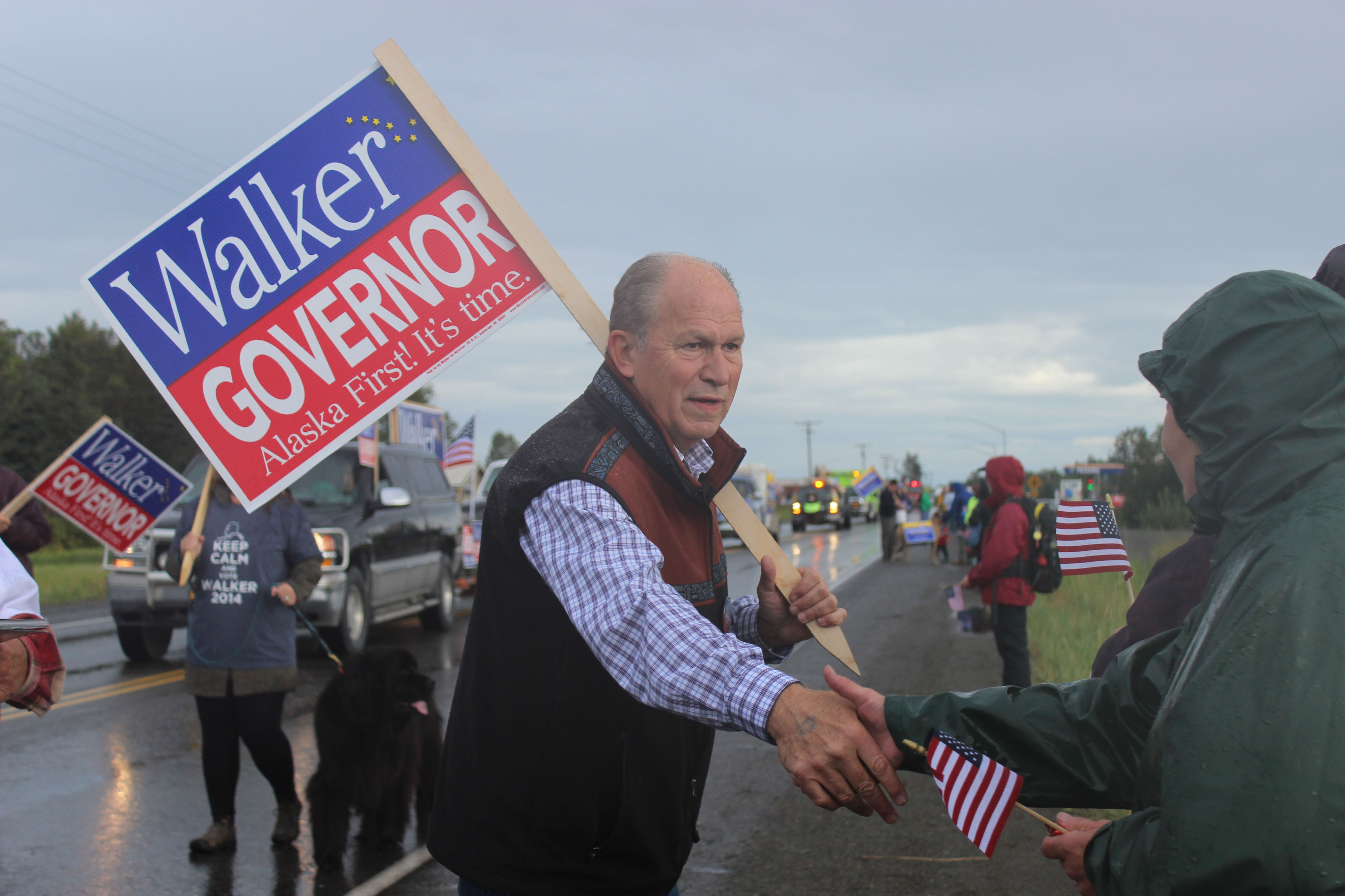 Bill Walker, gubernatorial candidate, greets spectators at the Kenai Peninsula Fair parade Saturday morning in Ninilchik.-Photo by McKibben Jackinsky; Homer News