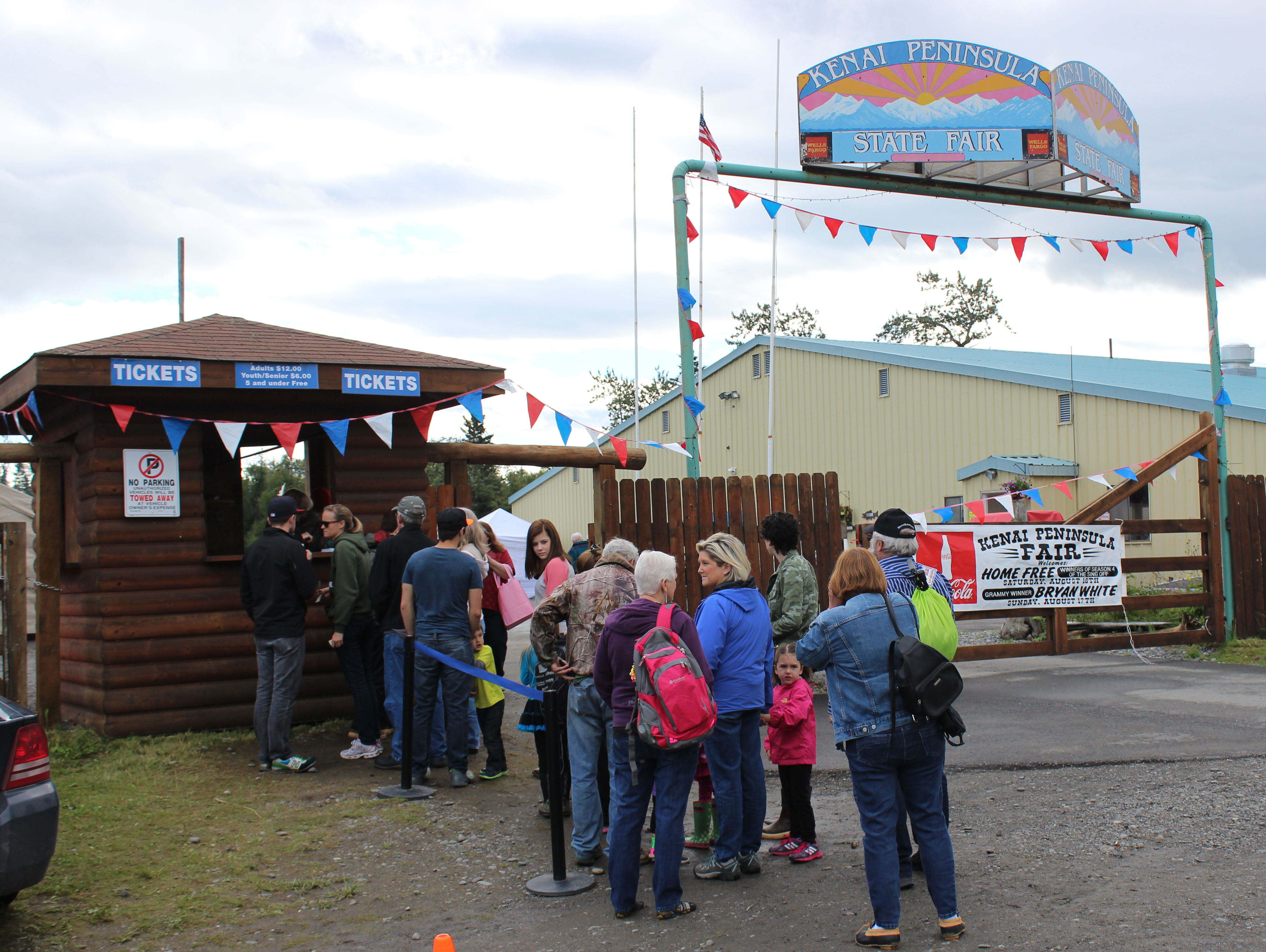 In spite of Saturday morning's rain, visitors lined up at the gate of the Kenai Peninsula Fair. -Photo by McKibben Jackinsky