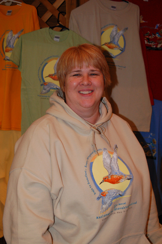 Debbie Dauphinais works the Kachemak Bay Shorebird Festival booth last Saturday at the Nutcracker Faire-Photo by Michael Armstrong, Homer News