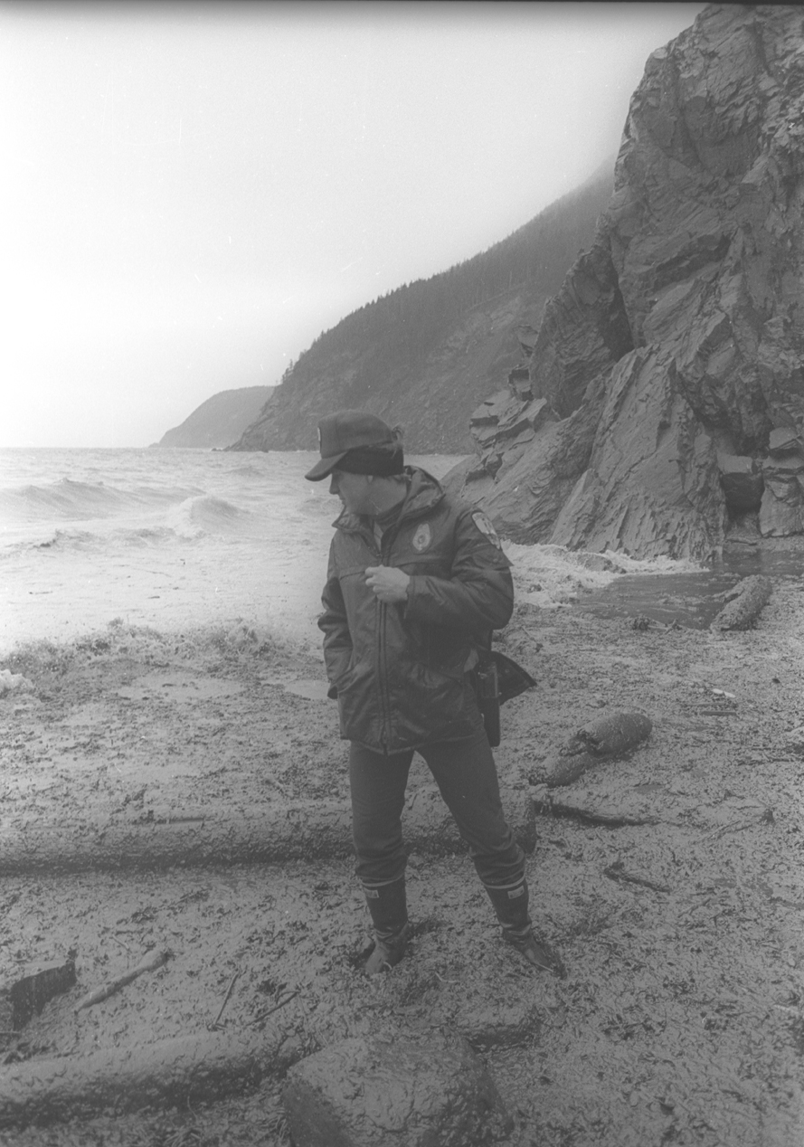 In May 1989, Roger MacCampbell, state park ranger, surveys the damage at Gore Point.-Photo by Tom Kizzia, Homer News