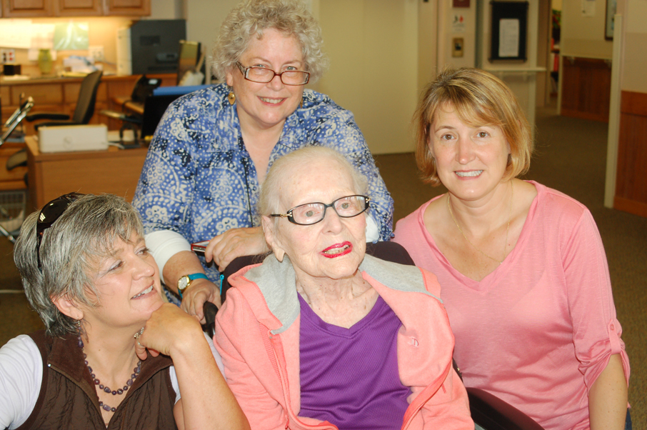 Clara Anderson, center, waits for cake at her 109th birthday party on Wednesday at South Peninsula Hospital Long Term Care. With her are granddaughters Kellie Blue, left, Jean Oldham, back, and grand-daughter-in-law Connie Oldham, right. Born July 2, 1905, in Kirksville, Mo., Anderson said her secret to a long life is “Work hard when you’re a kid. Grow up in the corn fields. Work and exercise, probably.”-Photo by Michael Armstrong, Homer News