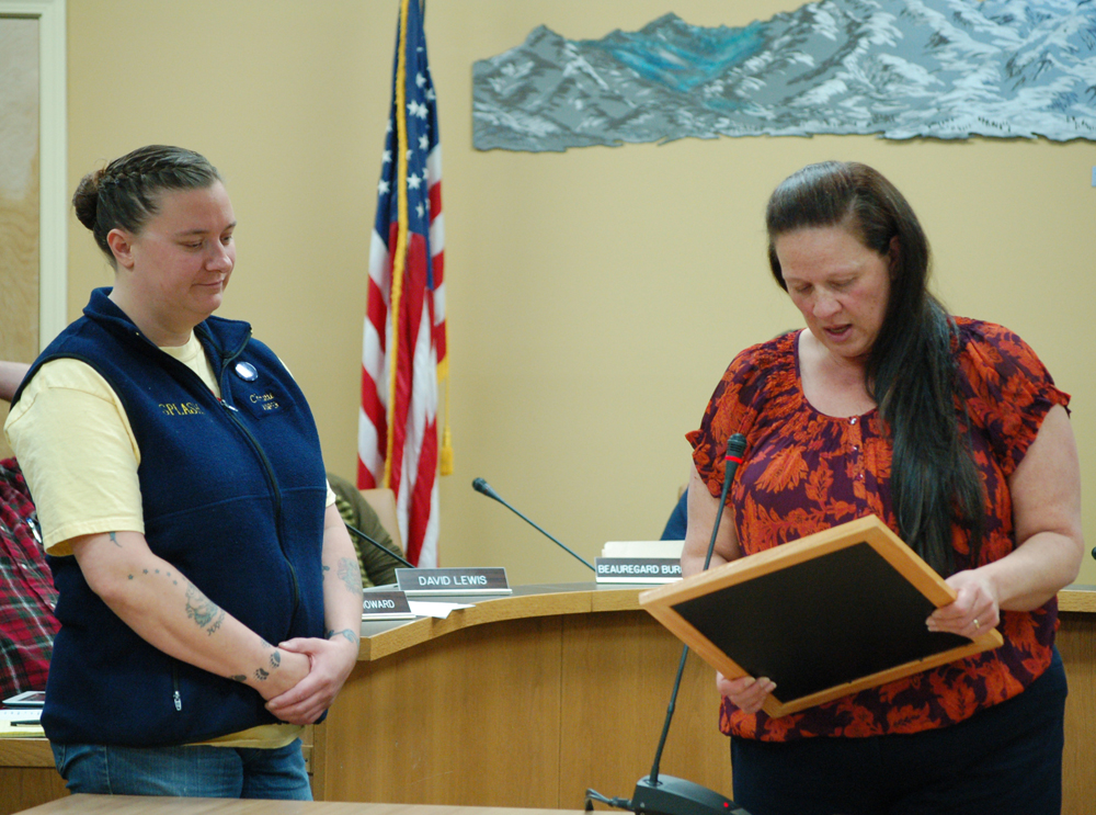 Christie Hill, left, listens as Mayor Beth Wythe, right, reads a proclamation honoring Hill for “braving frigid Alaska waters to fight cancer.” Hill is a frequent participant in the Polar Plunge and in the past 15 years has raised more than $200,000 for the American Cancer Society.-Photo by Michael Armstrong, Homer News