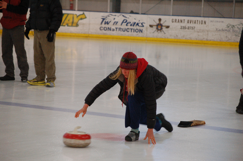 Michelle Hatten throws a stone durlng a curling demonstration at the Kevin Bell Arena in April 2014.-Photo by Michael Armstrong, Homer News
