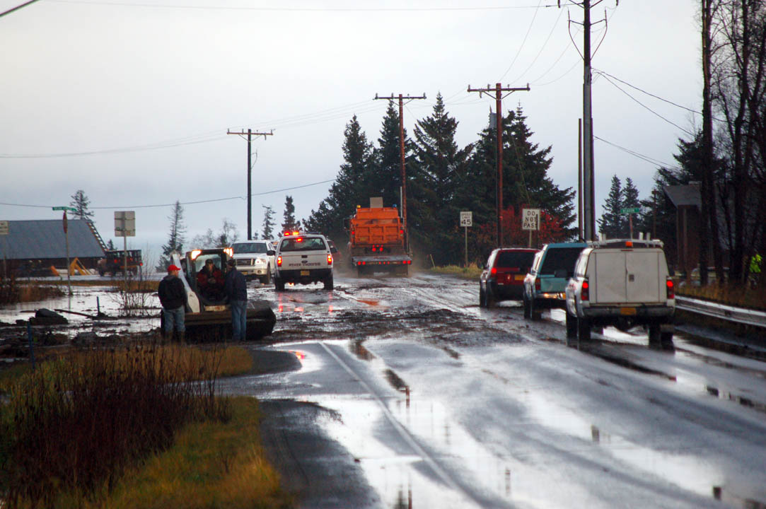 Traffic moves around a mudslide on East End Road and Bear Creek Drive on Monday before road crews closed it to clean up debris.-Photo by Michael Armstrong, Homer News
