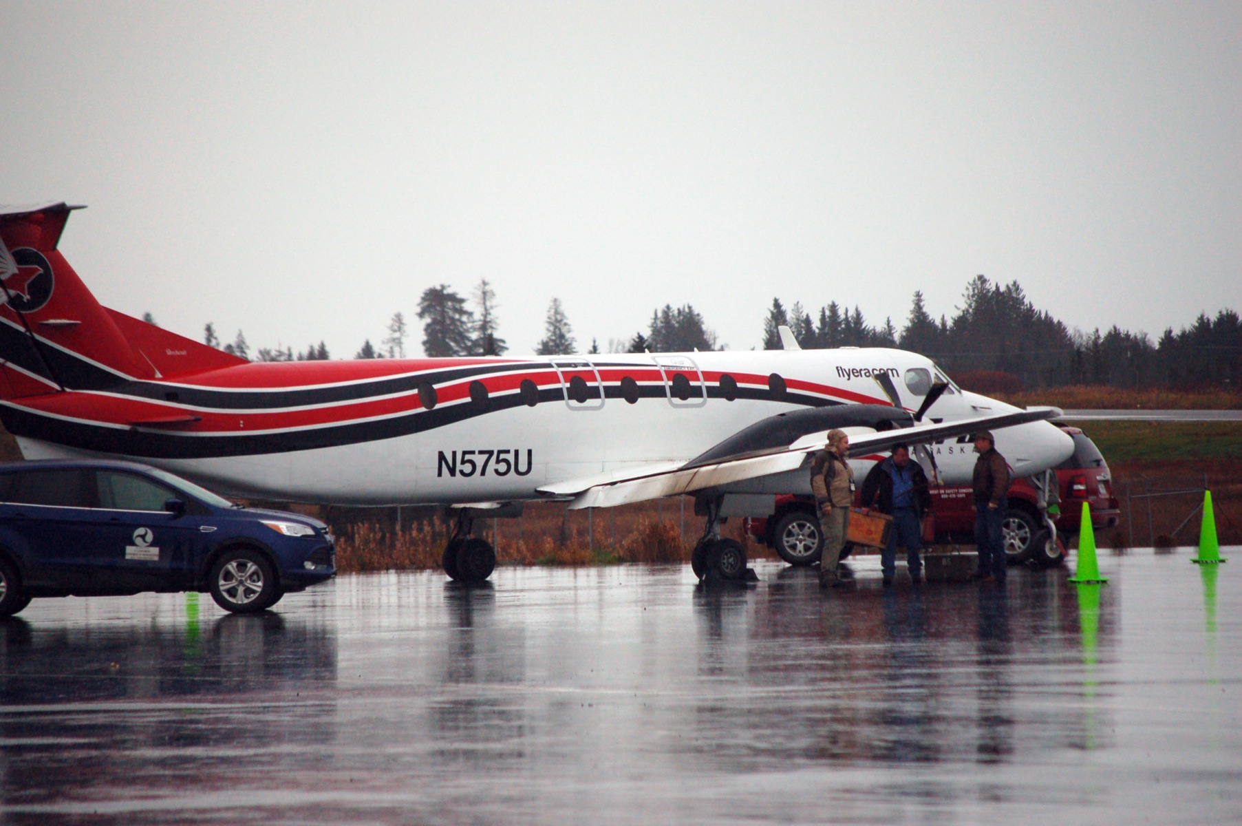 A Federal Aviation Administration car is parked Thursday at the Homer Airport next to the Era Alaska Beechcraft 1900C airplane that crashed on Wednesday. The plane has been raised on its landing gear. A carbon fiber composite propeller shows damage, as does one flap on the wing.-Photo by Michael Armstrong, Homer News