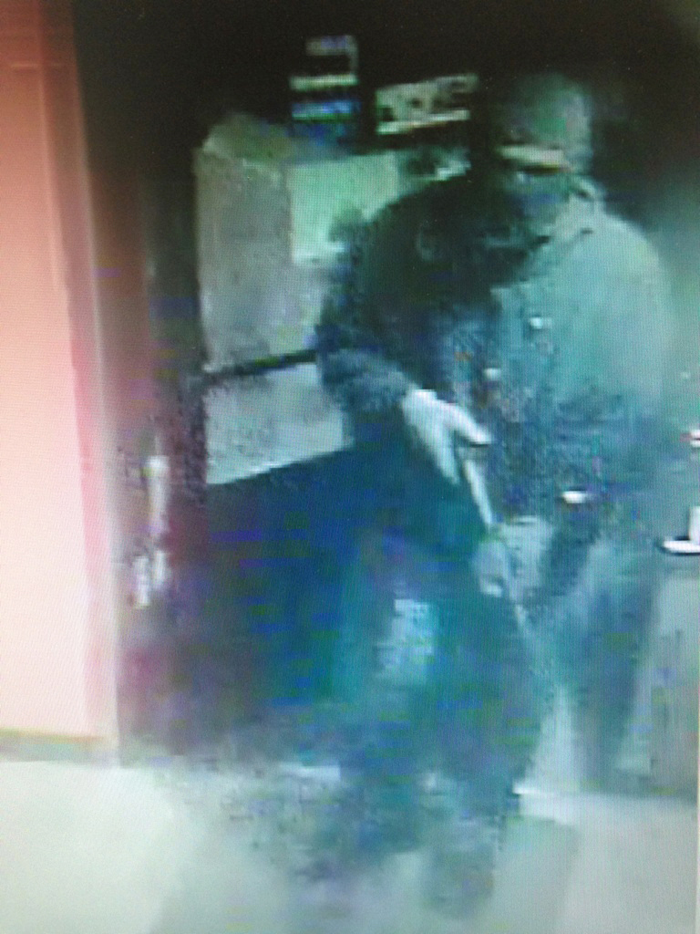 This enlarged version of a photo taken by security cameras at the Grog Shop shows the robber entering the store on Dec. 26 carrying what appears to be a Snakecharmer .410-caliber shotgun.-Photo provided, Homer Police Department