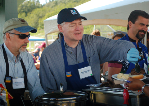 Deputy Commissioner of the Alaska Dept. of Transportation and Public Facilities Reuben Yost, left, and Lt. Gov. Mead Treadwell, right, serve food at the Governor’s Family Picnic.-Photo by Michael Armstrong, Homer News