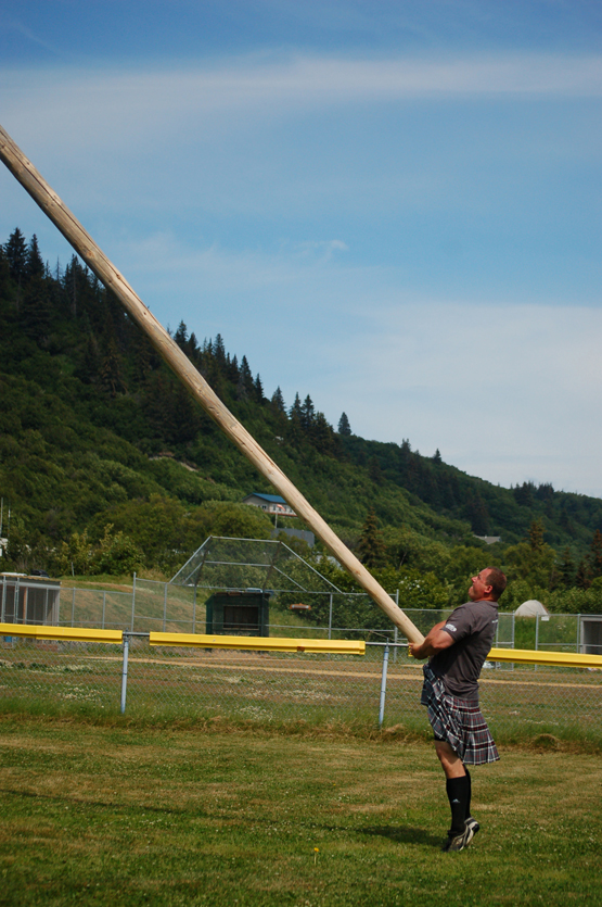 Jody Potosky tosses the caber in the amateur men’s event. He flipped the caber for a perfect 12 o’clock score.-Photo by Michael Armstrong, Homer News