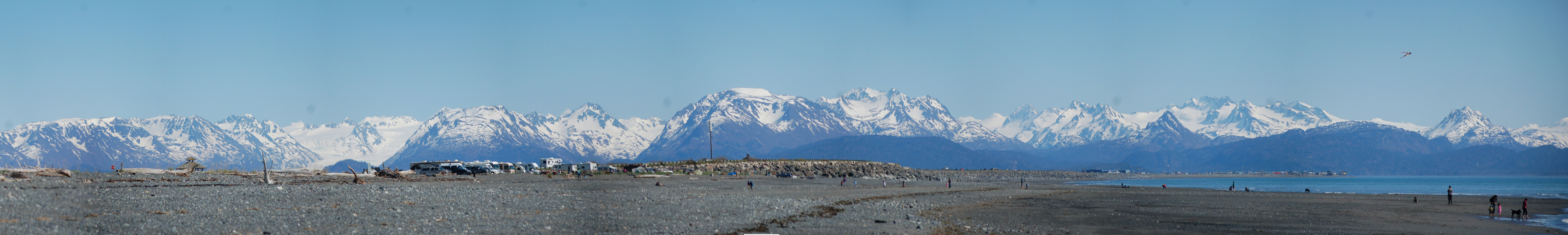 Beach walkers enjoy a sunny day earlier this month before smoke rolled over Kachemak Bay. The forecast calls for sunshine today, with cloudy skies this weekend.-Photo by Michael Armstrong, Homer News