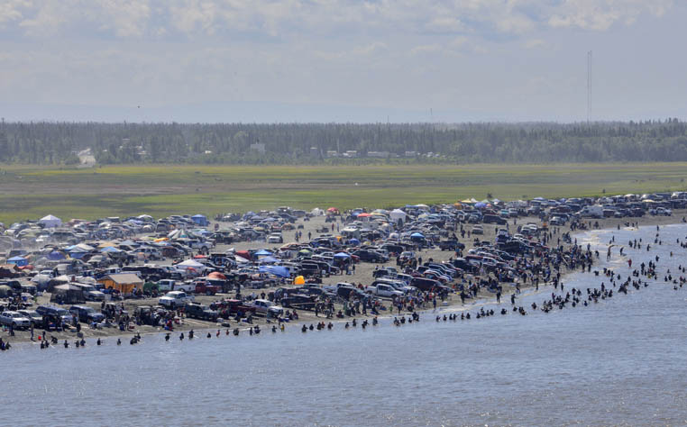 Droves of dipnetters crowd the beach along the Kenai River this past summer looking to fill their freezers with sockeye salmon in the personal use fishery open only to Alaska residents. The 2013 season featured a single-day record of nearly 250,000 sockeye entering the river on July 16, but many who missed out on that Tuesday bonanza had difficulty reaching their limit of 25 reds for a head of household and 10 for each additional family member.-Peninsula Clarion file photo