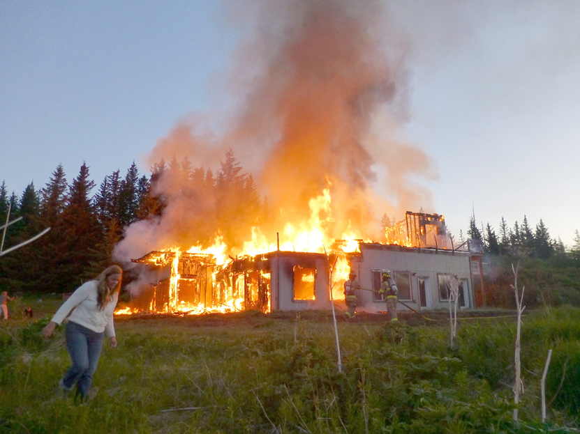Firefighters attack a fire at Alan Parks’ house on Diamond Ridge early last Thursday morning.-Photo by Sandra Cronland