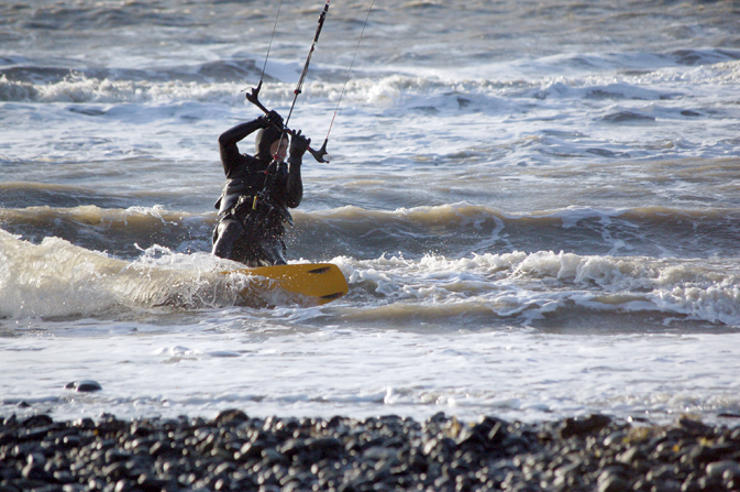 A kitesurfer cuts through waves.-Photo by Michael Armstrong, Homer News