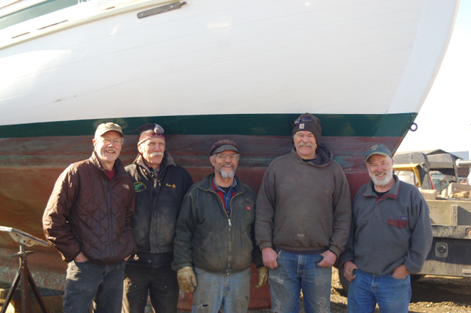 Members of the Kachemak Bay Wooden Boat Society pose with Homer Boat Yard owner Mike Stockburger after he moved the Indomita from West Hill to the boat yard on Kachemak Drive last Friday. A Homer man donated the ketch to the society. From left to right are Jim Lunny, John Miles, Bummpo Bremicker, Dave Seaman and Stockburger.-Photo by Michael Armstrong, Homer News