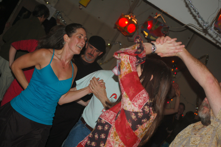 Couples swing their partners at Renn Tolman’s New Year’s Eve contra dance. -Michael Armstrong