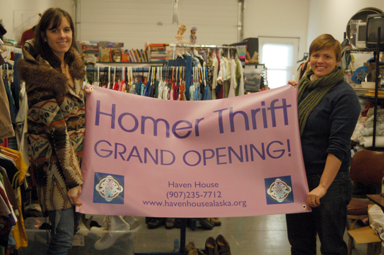 South Peninsula Haven House Executive Director Jessica Lawmaster, left, and victims services coordinator Rachel Romberg, right, hold up the Homer Thrift sign at the store on East End Road-Photos by Michael Armstrong, Homer News