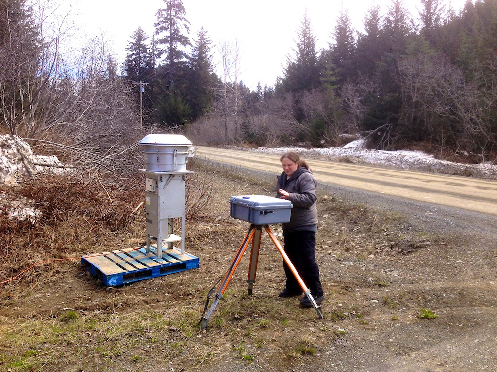 Tracie Merrill, environmental assistant for Seldovia Village Tribe, installs air quality monitoring equipment along Jakolof Bay Road in Seldovia.-Photo provided