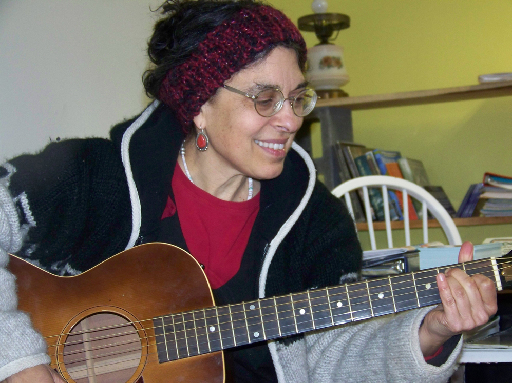 Lindianne Sarno entertains visitors during a break from moving into her new offices, Lindianne’s Music Garden, on West Pioneer Avenue.-Photo by McKibben Jackinsky, Homer News