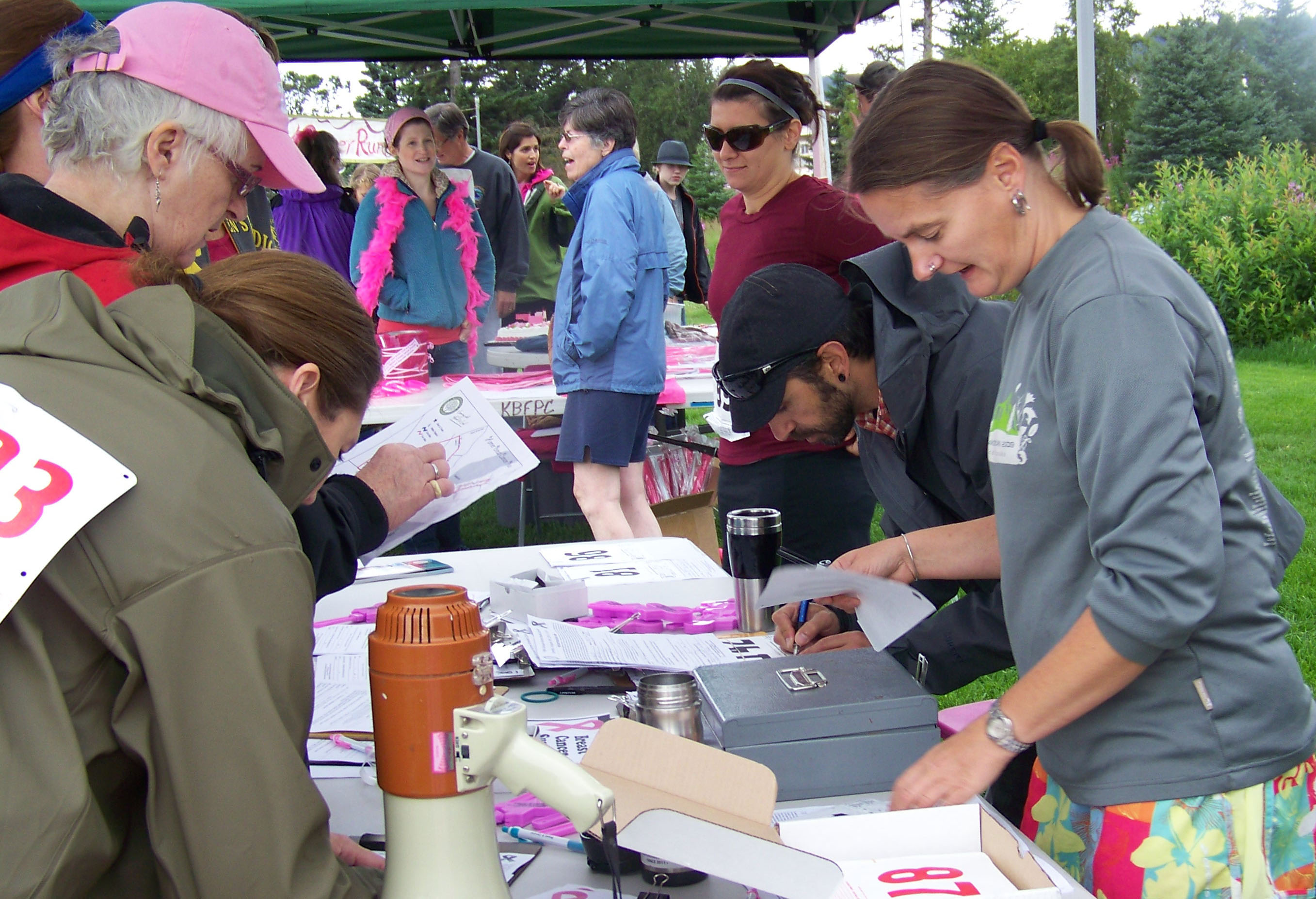 Catriona Lowe, right, of Kachemak Bay Family Planning Clinic, signs up participants in Sunday's Breast Cancer Run.-Photo by McKibben Jackinsky,  Homer News