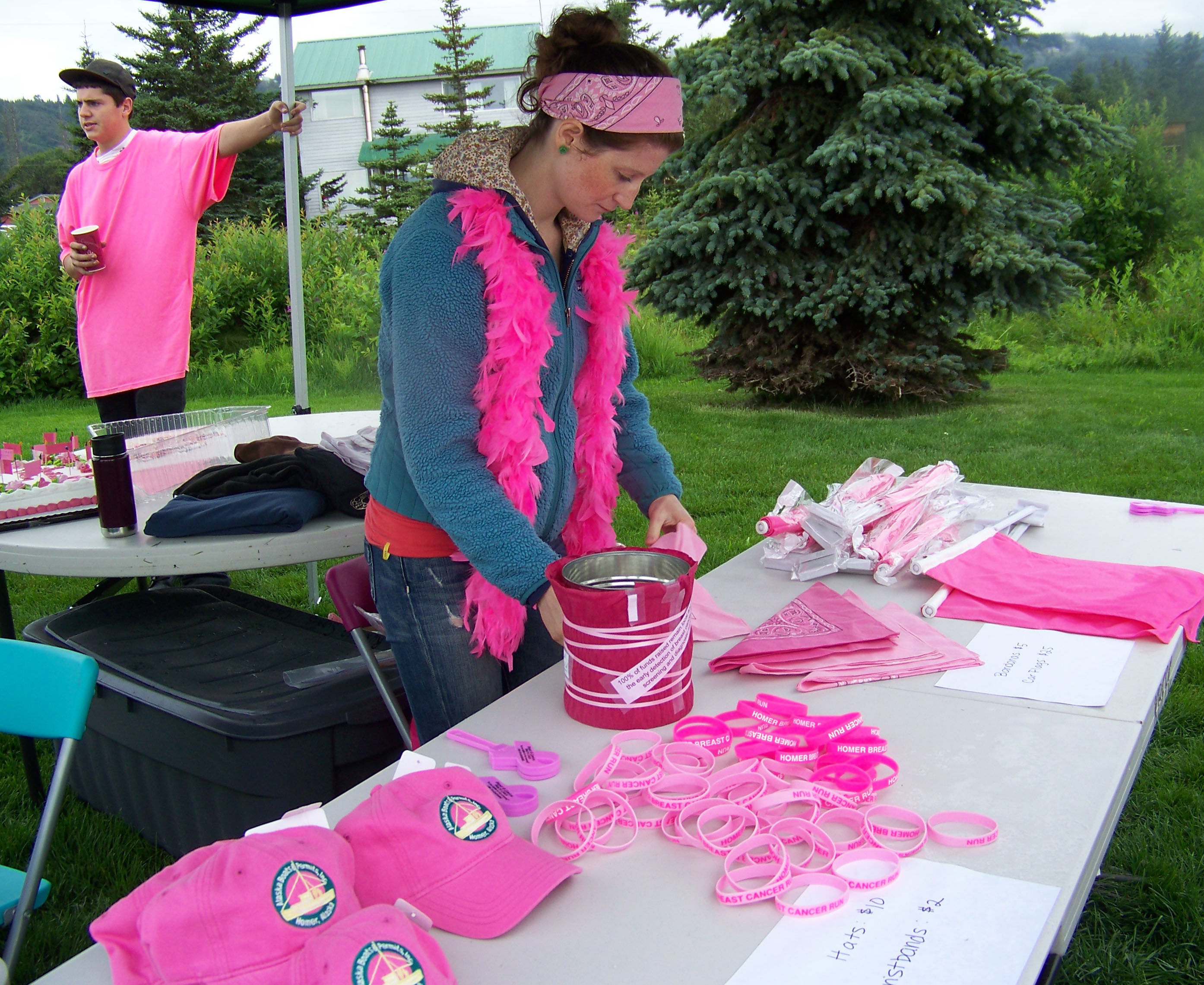 Clare Wheeler, a clinic assistant at Kachemak Bay Family Planning Clinic, ensures everyone at Sunday's Breast Cancer Run has something to wear that's pink, the color associated with breast cancer awareness. -Photo by McKibben Jackinsky,  Homer News