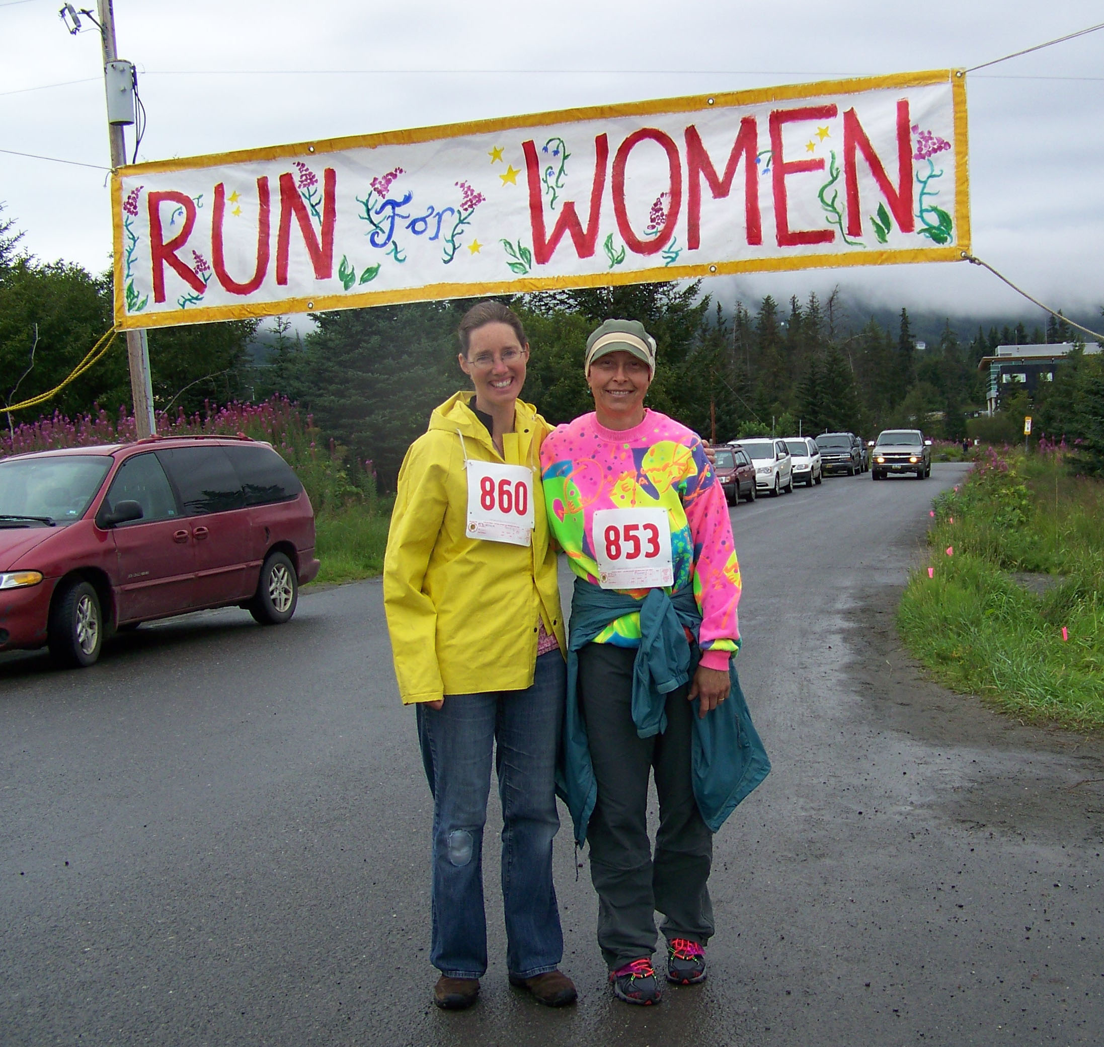 Jackie McDonough and Carmen Field cross the finish line of the Breast Cancer Run's one-mile walk on Sunday morning.-Photo by McKibben Jackinsky,  Homer News