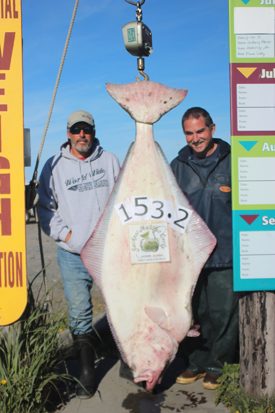 Greg Mendenhall of Port Orange, Fla., right, shows off the 153.2-pound halibut he caught June 15 while fishing with Capt. Rob Hyslip, left, of Big Bear Halibut Charters.-Photo provided