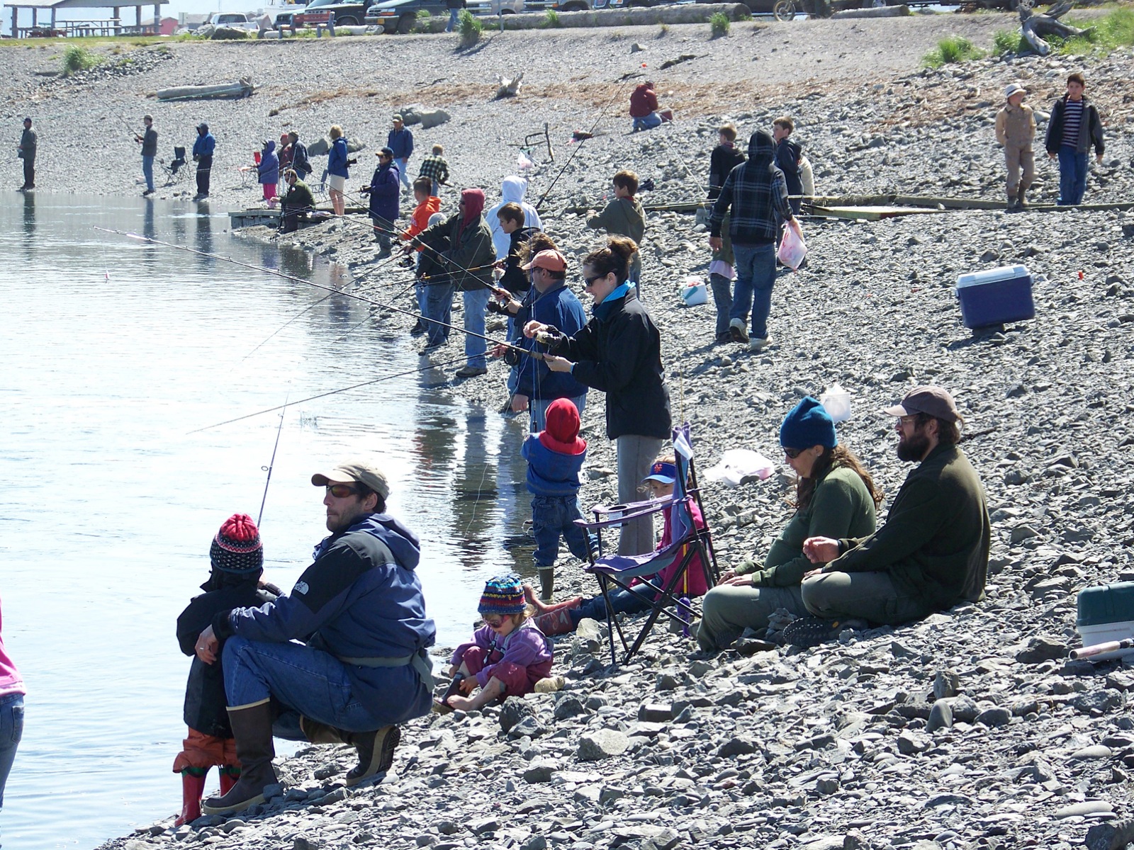 Youth anglers, assisted by parents, ring the Nick Dudiak Fishing Lagoon during the 2009 Kids Fishing Day.-Photo by McKibben Jackinsky, Homer News