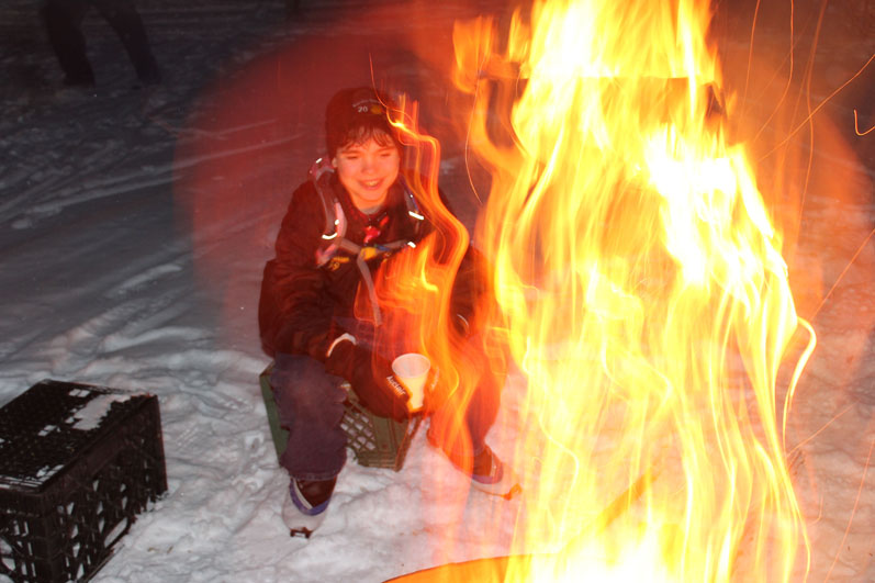 Spencer Warren enjoys the bonfire at Friday Night Lights.-Photo by McKibben Jackinsky, Homer News