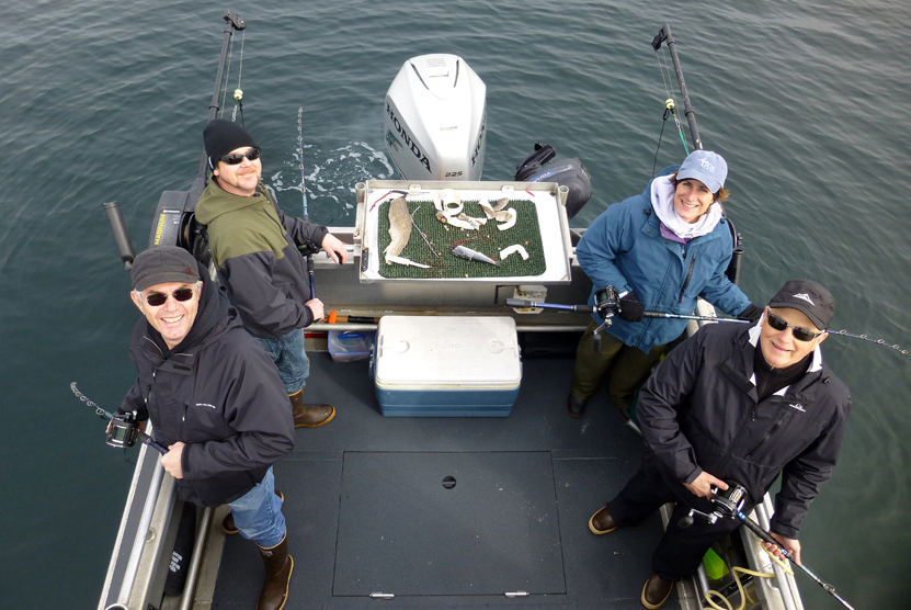 Homer Chamber of Commerce executive director Monte Davis and GCI sponsor representatives Kelly Snow, Mary Hart and Keith Sopp fish for halibut during the Homer Jackpot Halibut Derby tagging cruise May 2.-Photo by Jim Lavrakas