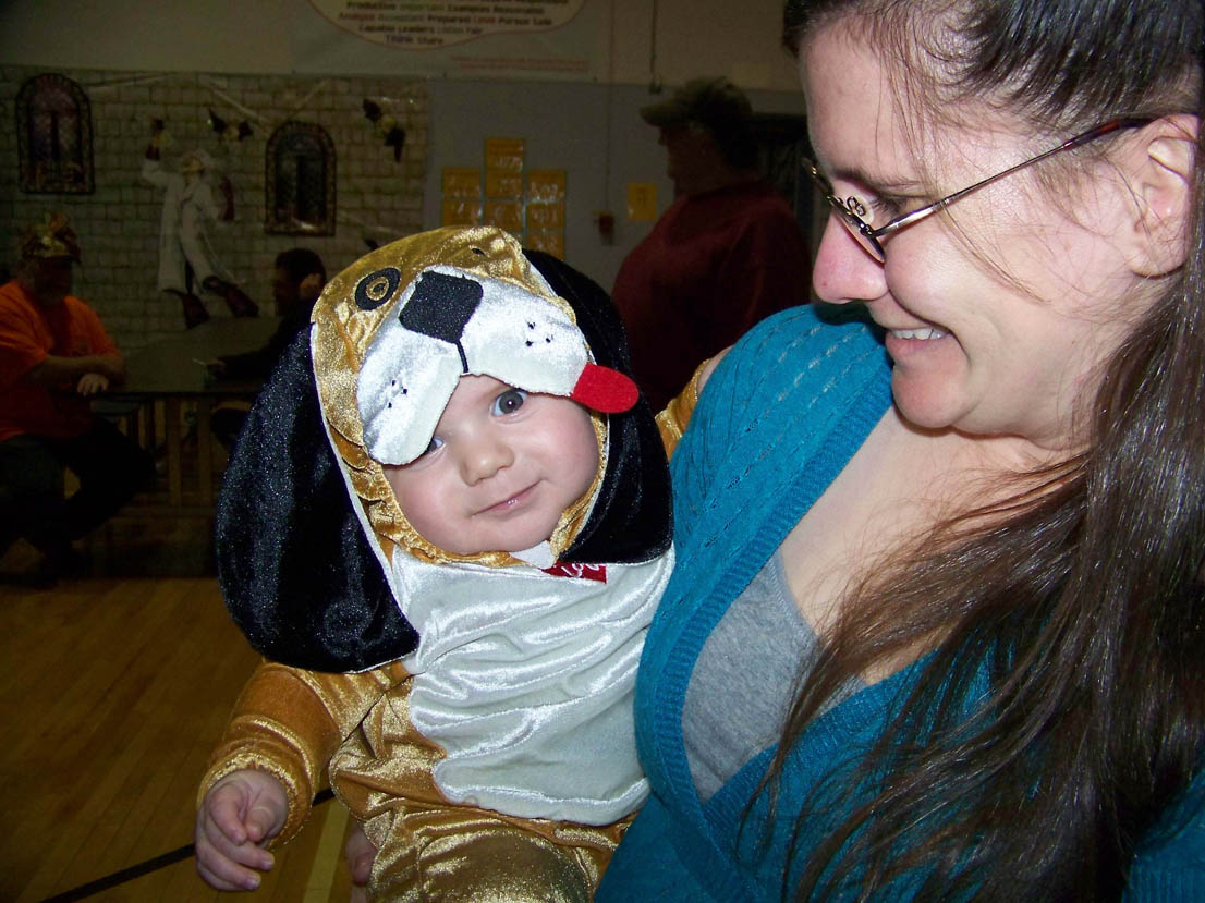 Puppy Jack Roderick, 5 months, cuddles with his mom, Stacey, at Chapman School's Halloween festivities last Friday. -Photo by McKibben Jackinsky, Homer News