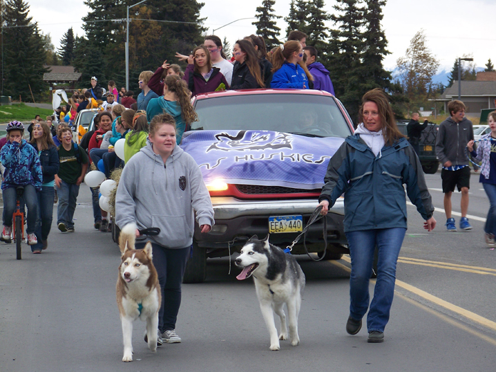 The Homer Middle School Huskies’ homecoming float was led by Principal Kari Dendurent, right, with Demon, and Jaime Sylva, left, with Lucien.-Photo by McKibben Jackinsky, Homer News