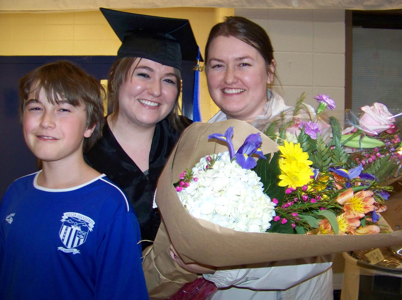 Surrounded by her brother Daniel, left, and sister Elikonida, right, valedictorian and student speaker Nina Reutov celebrates receiving her associate of arts degree at Kachemak Bay Campus’ May 8 commencement ceremony. -Photos by McKibben Jackinsky, Homer News
