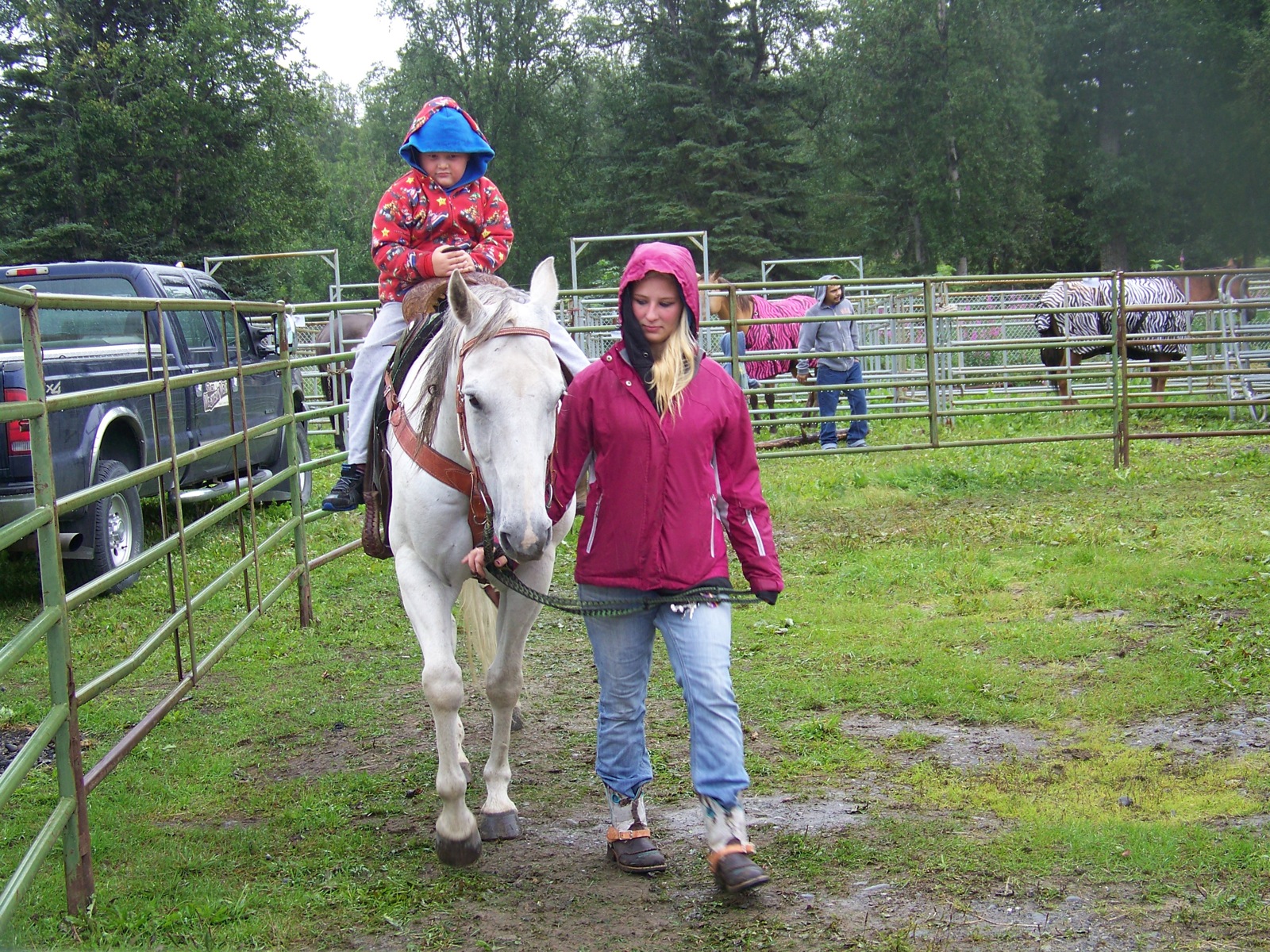A little rain won't stop Michael Houser, 6, of Soldotna, from taking advantage of a horse ride.-Photo by McKibben Jackinsky, Homer News