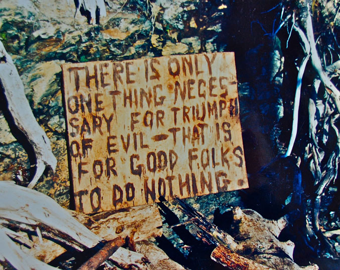 Using a piece of plywood and oil that washed up on the beach at Mars Cove for “ink,” Homer artist Mavis Muller created this sign to encourage cleanup volunteers at the cove.-Photos courtesy of Mavis Muller